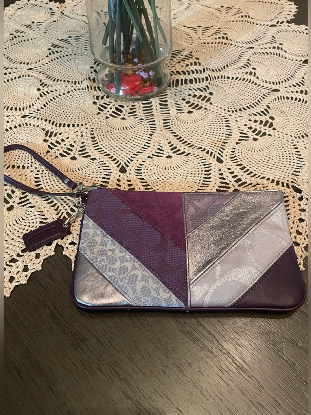 Coach patchwork collection wristlet featuring purple suede and metallic panels